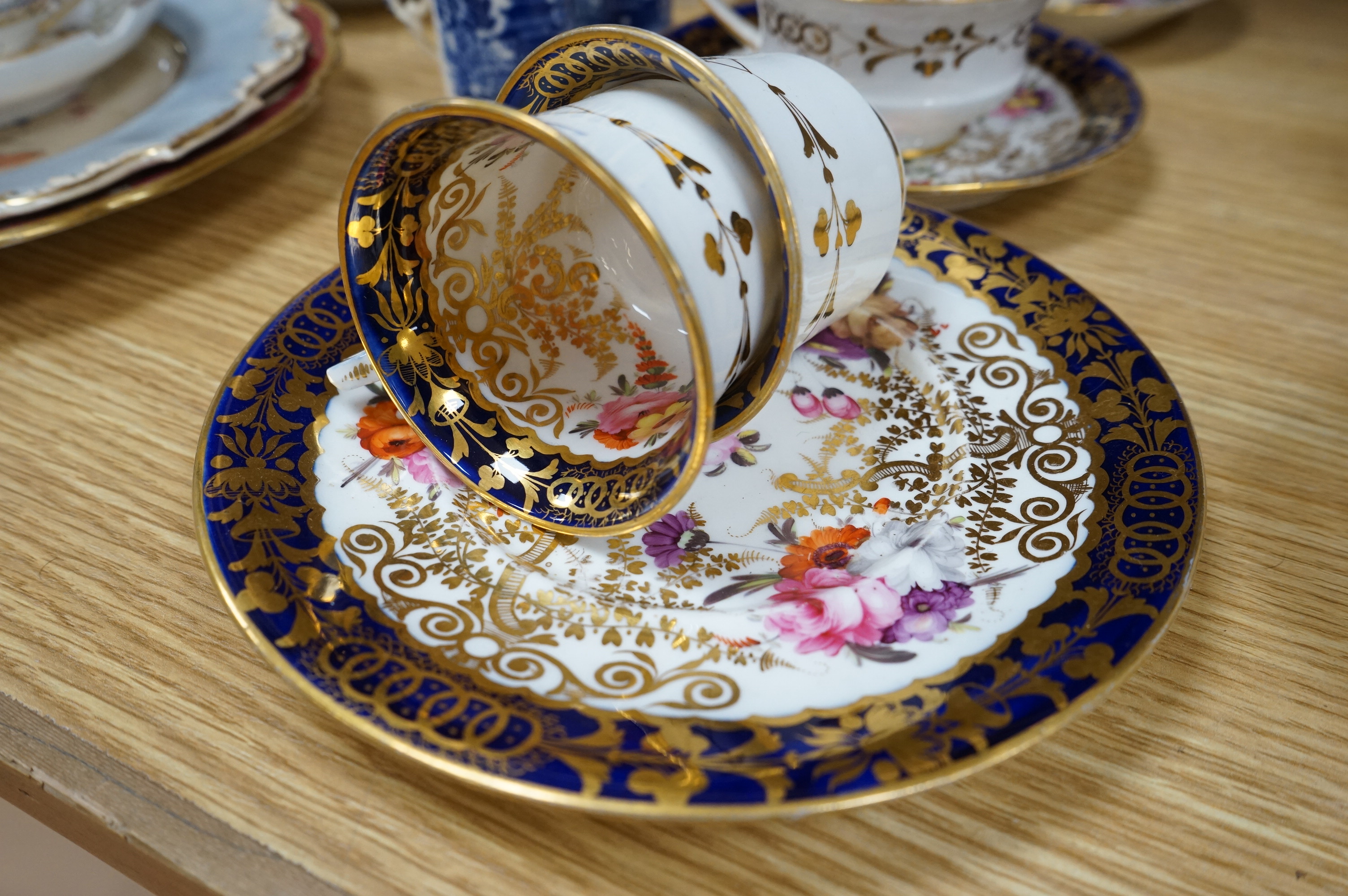 An English part teaset, c.1825 and six Royal Crown Derby coffee cans and saucers etc. Condition - some items cracked chipped and losses to gilding, teapot cover finial broken